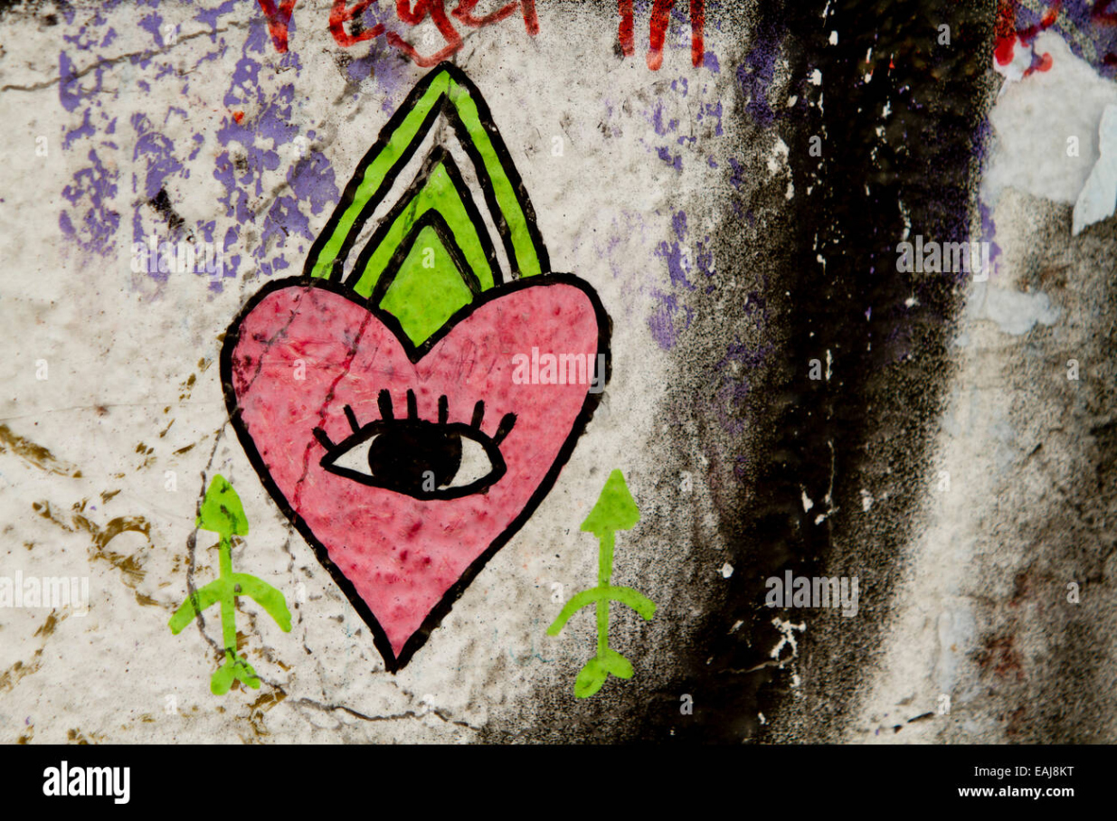 Graffiti street art Berlin wall tags eye heart Stock Photo - Alamy