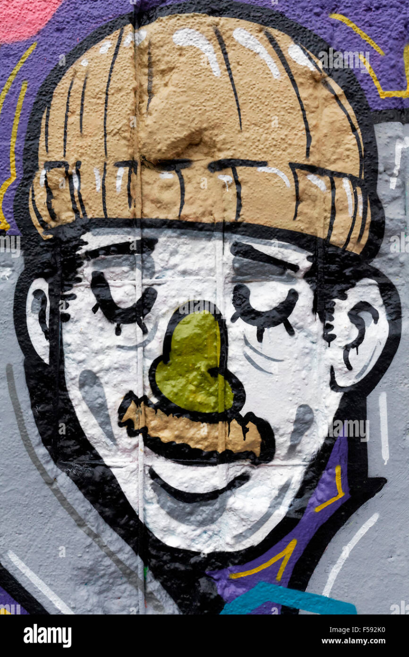 Hombre sonriendo con gorro de lana y el bigote, graffiti, street