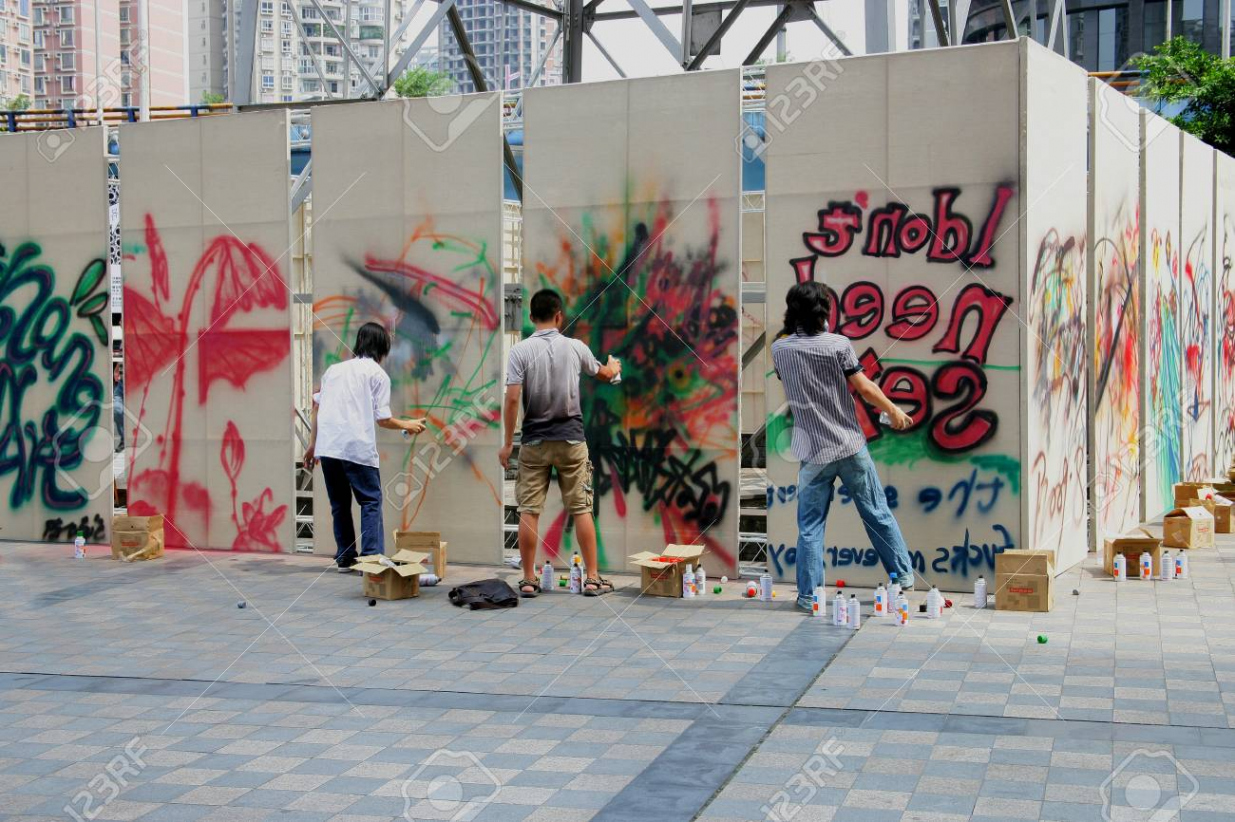 People Drawing Graffiti On Canvas In City Stock Photo, Picture and