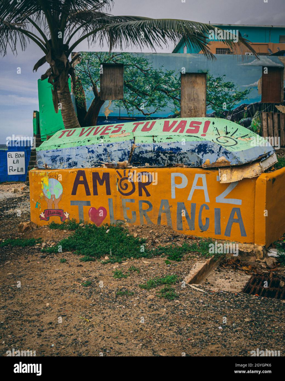 Piece of stone decorated with graffiti art of words Love, Peace