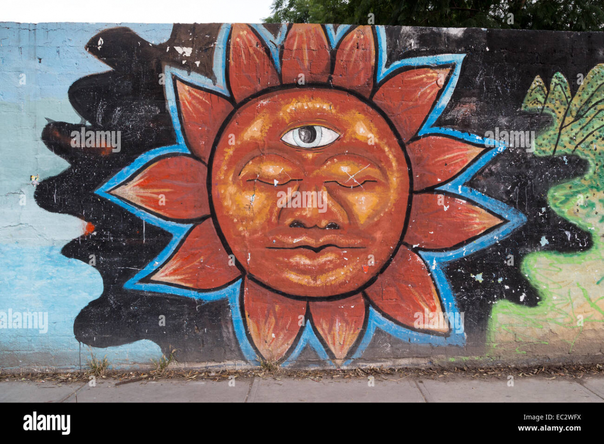 Urban art depicting the sun with a face in the Spanish colonial