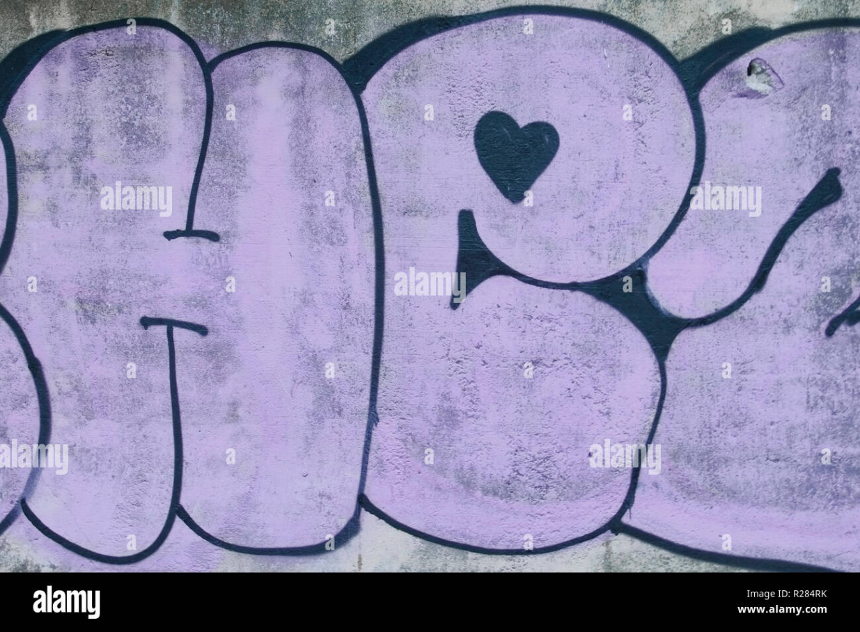 Violet graffiti on a concrete wall texture a background Stock