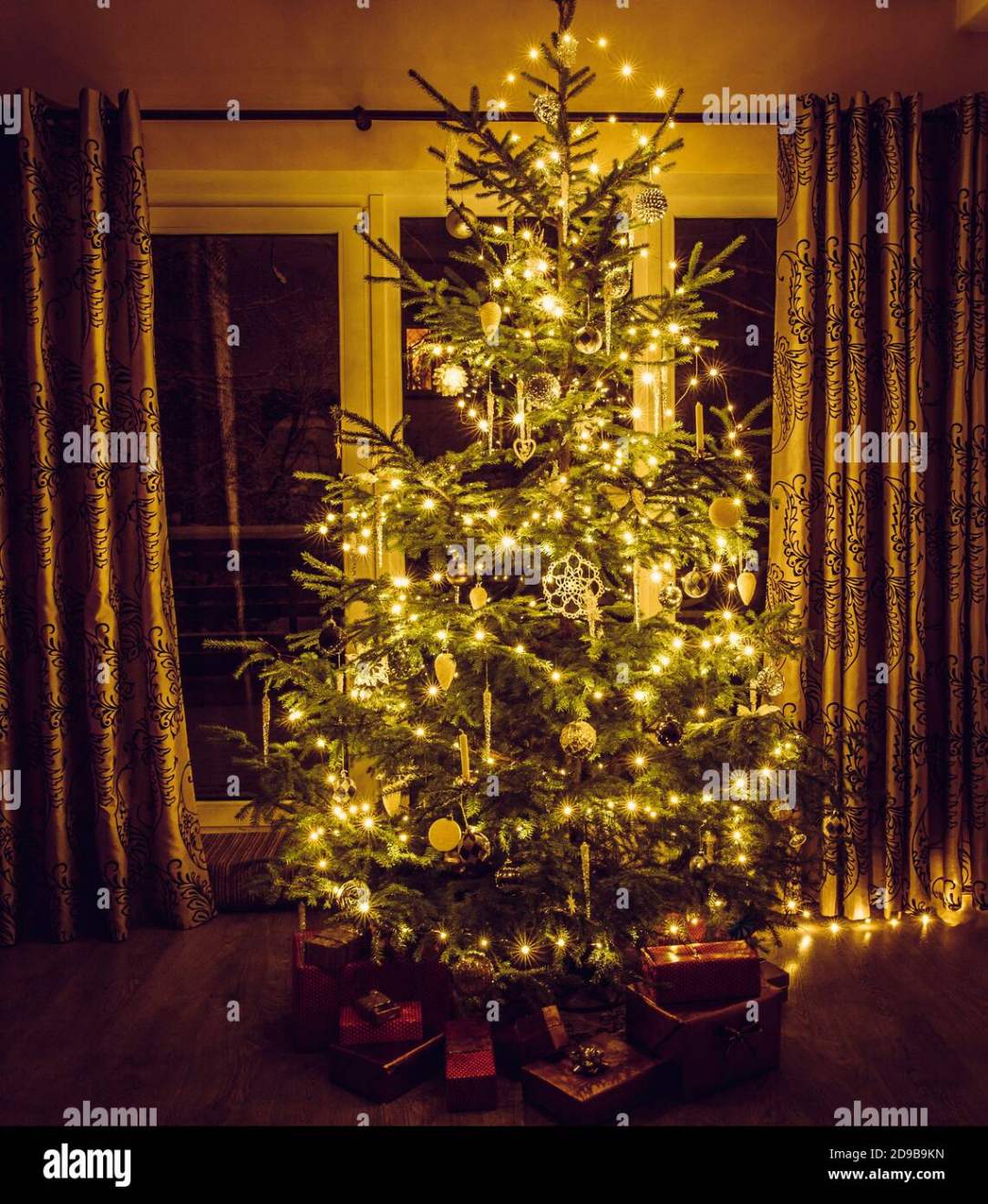 Christmas tree with warm yellow string lights and white icicles