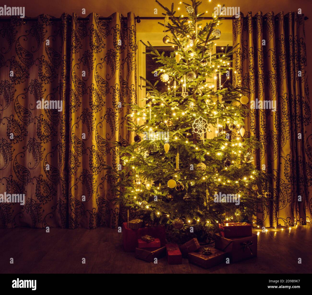 Christmas tree with warm yellow string lights and white icicles