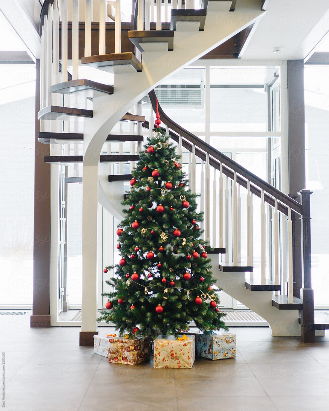 Decorated Fir Tree Under Stairs" by Stocksy Contributor "Duet