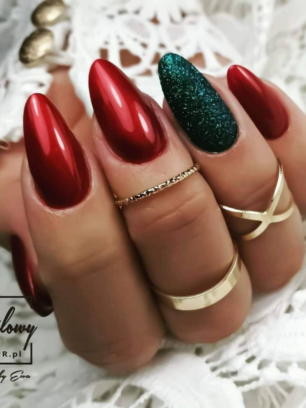 Stunning glossy red almond shaped Christmas nails with an accent